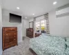 Carpeted bedroom with recessed lighting, baseboards, an AC wall unit, and crown molding