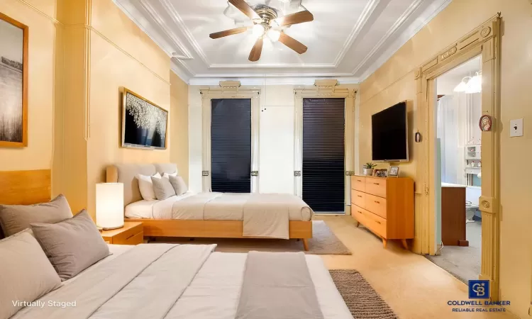 Bedroom with light carpet, ceiling fan, and crown molding