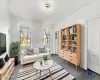 Living area with dark carpet and crown molding