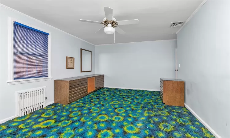 Bedroom featuring crown molding,  and large walk in closet