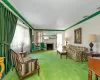 Living area with  a fireplace, crown molding, and carpet