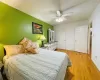 Bedroom featuring baseboards, a ceiling fan, and light wood finished floors