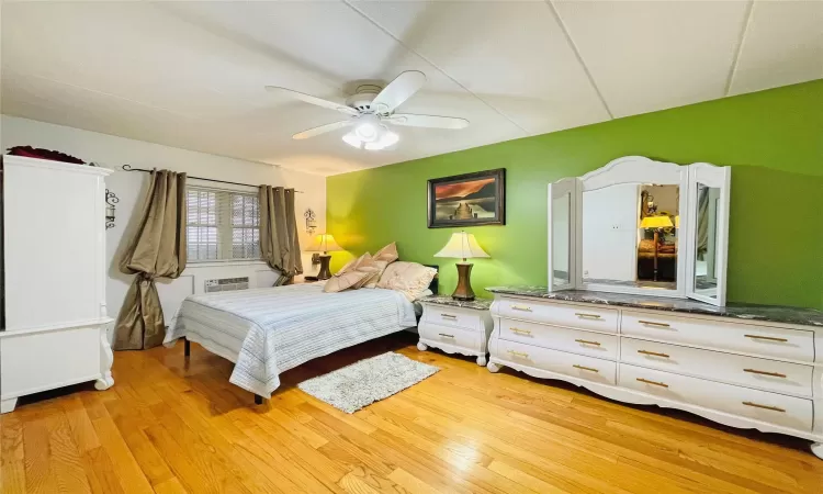 Bedroom with ceiling fan and light wood finished floors