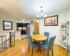 Dining area featuring a notable chandelier, light wood-style flooring, and baseboards