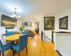 Dining room with baseboards, a notable chandelier, and light wood-style flooring