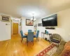 Dining room featuring an inviting chandelier, baseboards, and light wood-type flooring