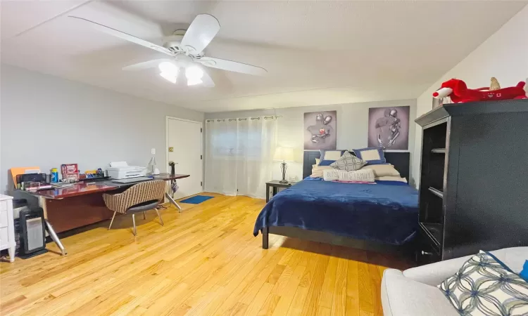 Bedroom featuring a ceiling fan and wood finished floors