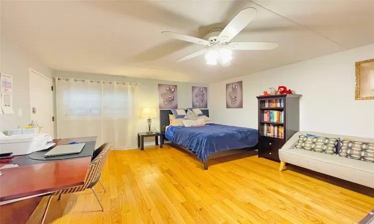 Bedroom featuring light wood-style flooring and a ceiling fan