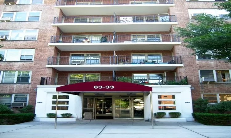 View of building exterior featuring cooling unit