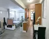 Kitchen featuring open floor plan, light countertops, light wood-style flooring, freestanding refrigerator, and brown cabinetry