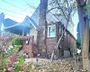 View of side of home featuring brick siding, stone siding, and a chimney