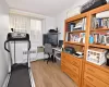 Office space featuring radiator and light wood-type flooring