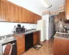 Kitchen with stainless steel microwave, dark countertops, dishwasher, and freestanding refrigerator