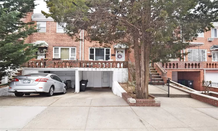 Multi unit property featuring brick siding and driveway