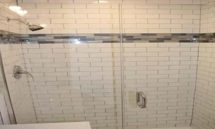 Full bathroom featuring a stall shower