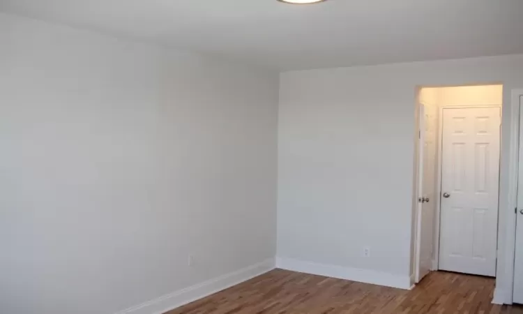 Unfurnished room with baseboards and wood finished floors