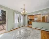 Unfurnished dining area featuring visible vents, baseboard heating, ornamental molding, and light wood-style flooring