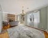 Living area featuring visible vents, a fireplace, ornamental molding, hardwood / wood-style flooring, and a baseboard heating unit