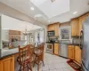 Kitchen with light tile patterned floors, stainless steel appliances, a healthy amount of sunlight, and ornamental molding