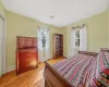 Bedroom featuring visible vents, baseboards, a baseboard heating unit, and light wood-style flooring