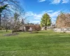 View of yard featuring a wooden deck and fence