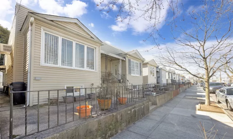 View of home's exterior featuring a fenced front yard and a residential view