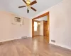 Empty room with ceiling fan, visible vents, wood finished floors, and crown molding