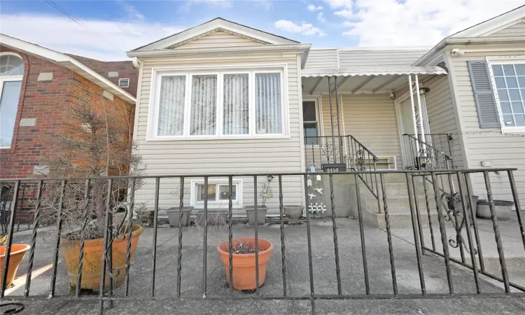 View of front facade with a fenced front yard and a gate