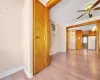 Empty room featuring visible vents, a wall unit AC, light wood-style floors, baseboards, and ceiling fan