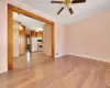 Unfurnished living room featuring light wood finished floors, visible vents, crown molding, baseboards, and a ceiling fan