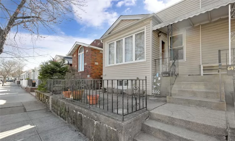 View of side of home with fence