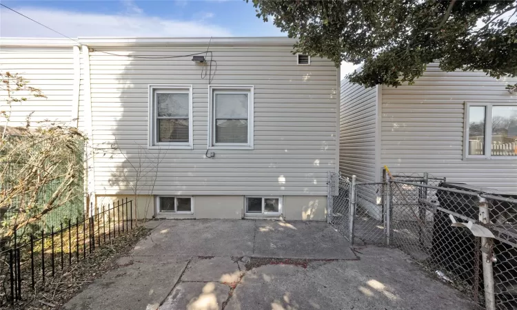 Back of house with a patio and fence