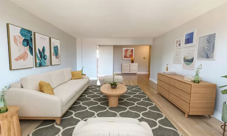 Living area featuring baseboards and light wood-style floors