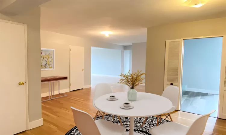 Dining space featuring light wood-type flooring and baseboards