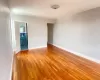 Unfurnished room featuring light wood finished floors and baseboards