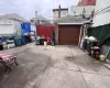 Garage featuring concrete driveway and fence