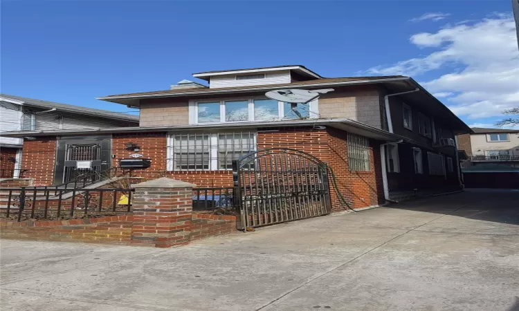 View of front of house with brick siding and concrete driveway