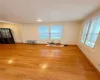 Empty room with radiator heating unit, light wood-type flooring, and baseboards