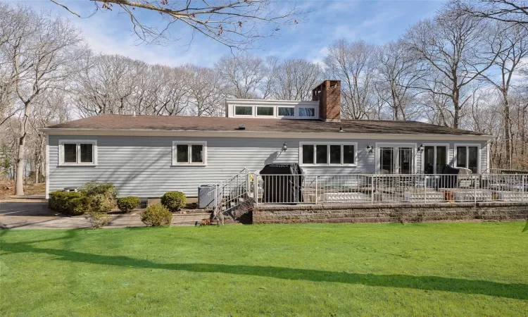 View of front of home featuring a front lawn and a chimney