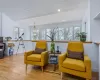 Living room with plenty of natural light, light wood-type flooring, and high vaulted ceiling