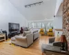 Living room with a wealth of natural light, baseboards, and light wood-style floors