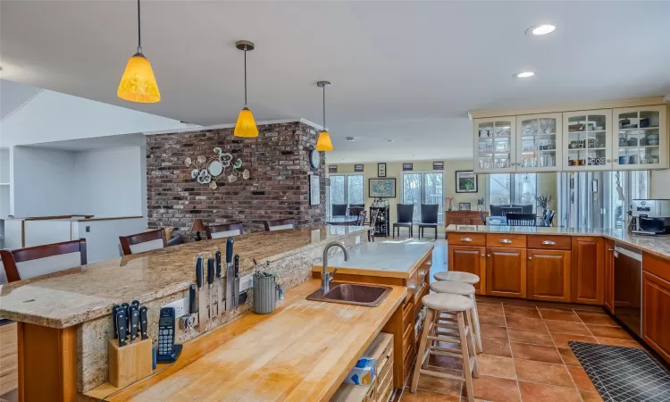 Dining area featuring light wood-style flooring, recessed lighting, and a fireplace