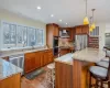 Kitchen with a sink, glass insert cabinets, plenty of natural light, and dishwasher