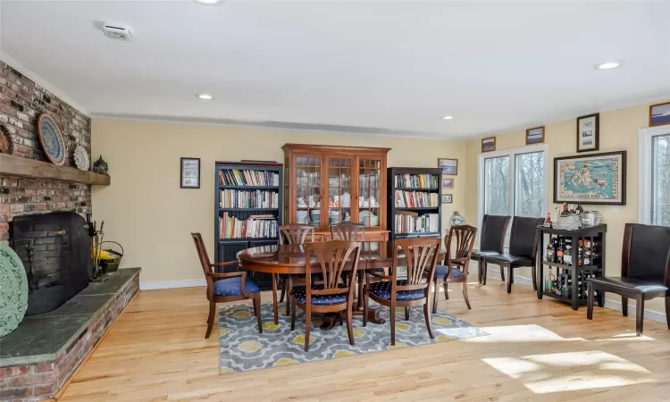 Dining room with crown molding, recessed lighting, and wood finished floors