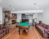 Recreation room featuring tile patterned flooring, visible vents, recessed lighting, and a brick fireplace