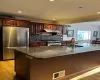 Kitchen with a sink, visible vents, appliances with stainless steel finishes, and under cabinet range hood