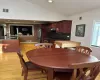 Dining space featuring vaulted ceiling, light wood-style floors, and visible vents