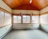 Unfurnished sunroom with wooden ceiling, a baseboard heating unit, lofted ceiling, and a baseboard radiator