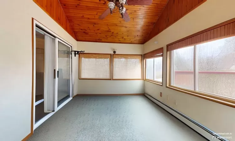 Unfurnished sunroom featuring a baseboard heating unit, wood ceiling, a ceiling fan, and vaulted ceiling