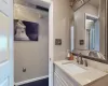 Bathroom featuring visible vents, vanity, and baseboards